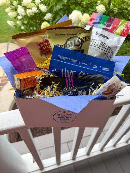 Classic Welcome Box packed with Michigan snacks in blue tissue paper